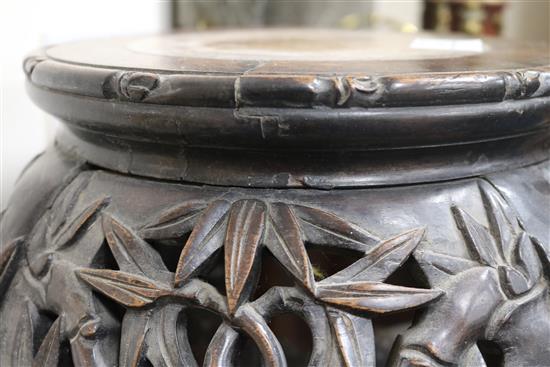 A Chinese carved hardwood marble inset jardiniere stand W.35cm